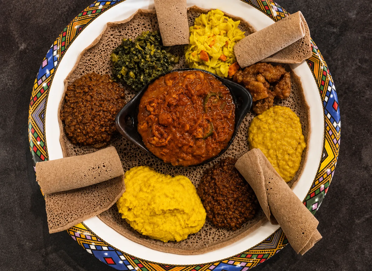Shared Ethiopian platters and freshly made injera at Mesob Ethiopian Eats in Winnipeg